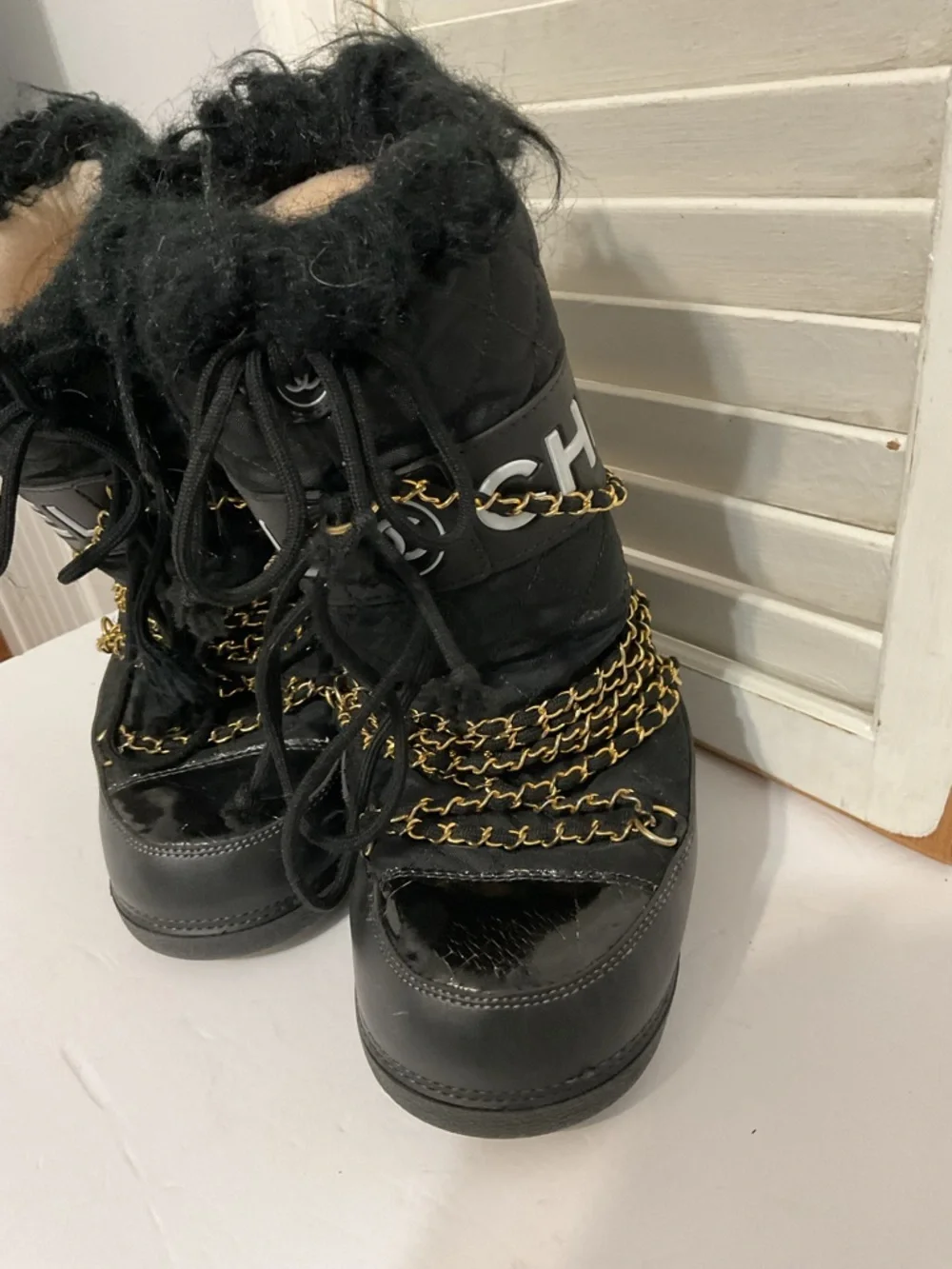 CHANEL Black and Gold Quilted Winter Lace-Up Boots